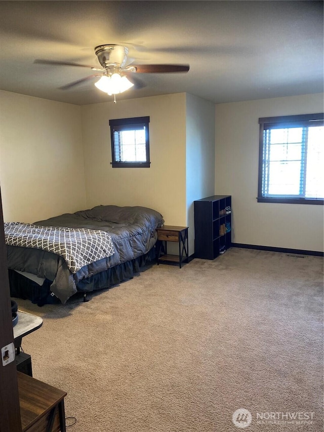 bedroom featuring ceiling fan and carpet