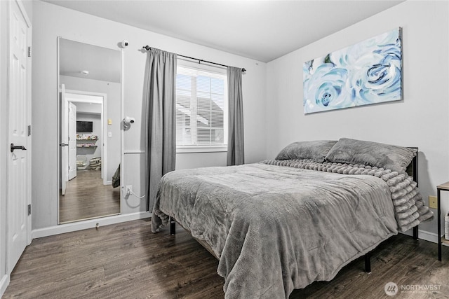 bedroom featuring baseboards and wood finished floors