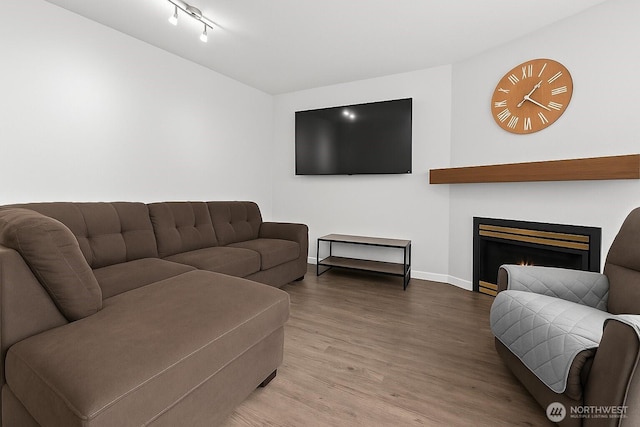 2709 Maplewood Ave Unit 304, Bellingham, WA 98225 - living room with wood finished floors, baseboards, and a warm lit fireplace