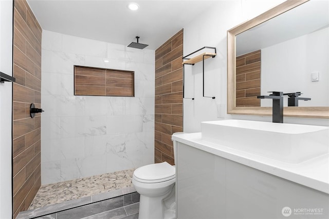 full bath featuring vanity, recessed lighting, a tile shower, and toilet