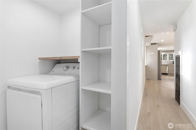 laundry area featuring laundry area, washer / dryer, baseboards, recessed lighting, and light wood finished floors