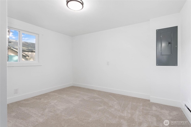 carpeted empty room with baseboards and electric panel