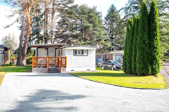 view of front of home with a front yard and crawl space