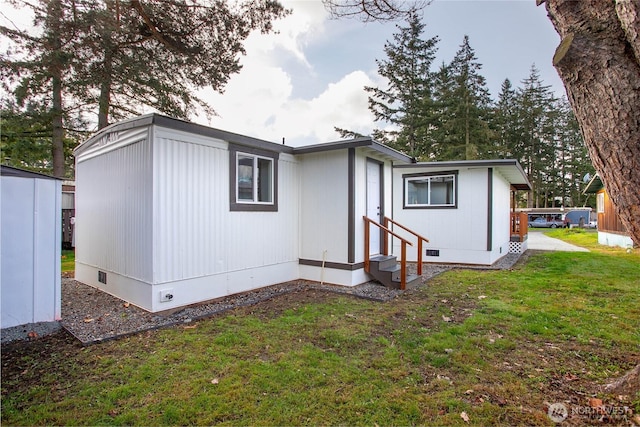 view of front of property with a front yard, crawl space, and entry steps