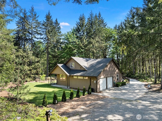 view of property exterior featuring a garage, fence, concrete driveway, a lawn, and a view of trees