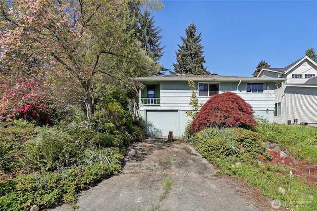 single story home featuring concrete driveway and an attached garage