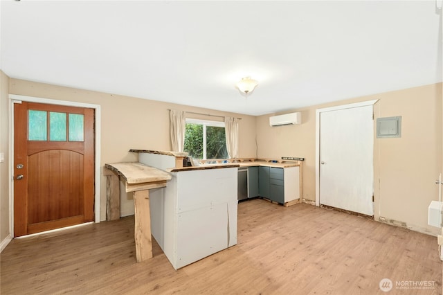 24005 SE 132nd Way, Issaquah, WA 98027 - kitchen featuring a wall unit AC, light wood-style floors, stainless steel dishwasher, and light countertops