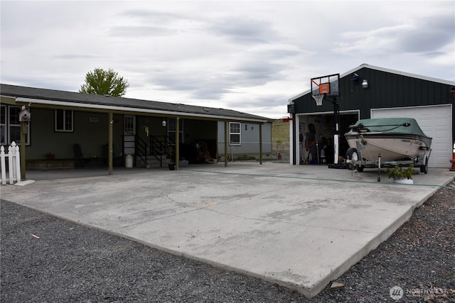 exterior space featuring driveway, an outbuilding, and a garage
