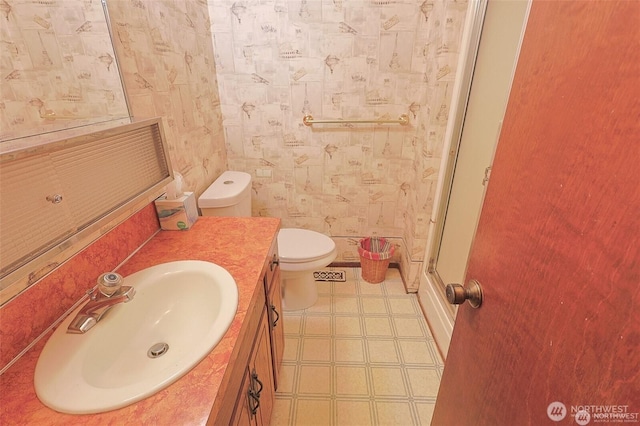 bathroom with tile patterned floors, a shower stall, vanity, and toilet