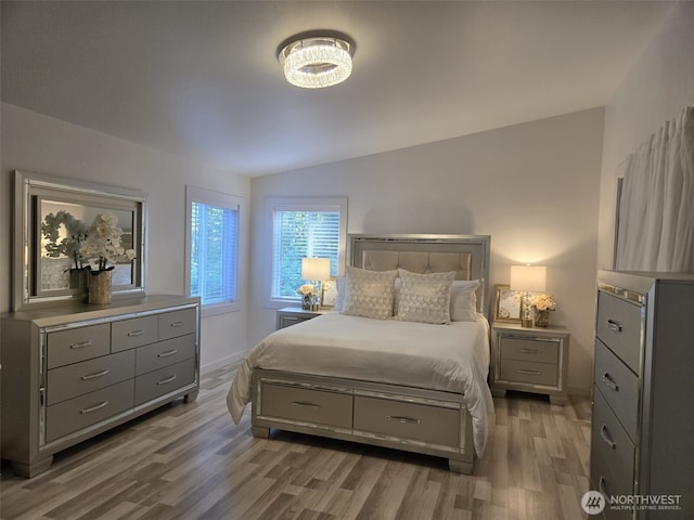 31101 116th Ave SE Unit 30, Auburn, WA 98092 - bedroom with wood finished floors, vaulted ceiling, a chandelier, and baseboards