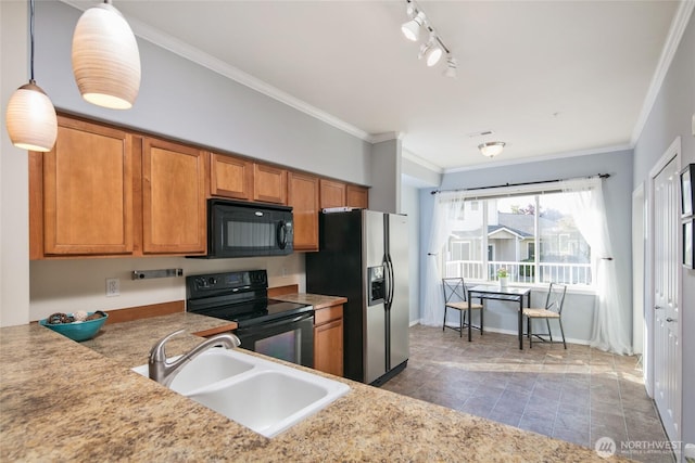 kitchen featuring crown molding, brown cabinets, a sink, light countertops, and black appliances