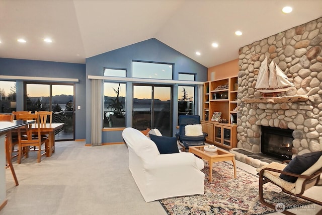 1491 Olympic Heights Ln, Freeland, WA 98249 - living area with high vaulted ceiling, light carpet, recessed lighting, and a stone fireplace