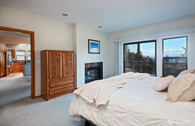 1491 Olympic Heights Ln, Freeland, WA 98249 - bedroom with a glass covered fireplace, light carpet, and freestanding refrigerator