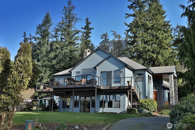 1491 Olympic Heights Ln, Freeland, WA 98249 - rear view of property featuring a yard, a wooden deck, and a chimney