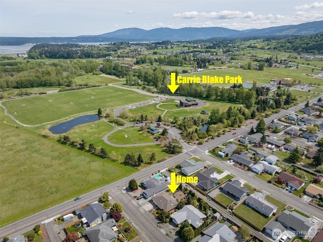 aerial view featuring a water and mountain view and a residential view