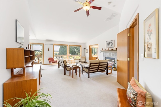 living room featuring lofted ceiling, a fireplace, light colored carpet, a wall unit AC, and a ceiling fan