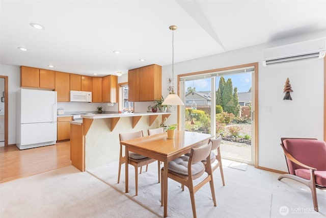 dining room with light colored carpet, recessed lighting, and a wall mounted AC