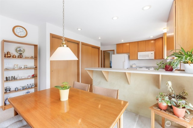 dining area featuring recessed lighting and light carpet