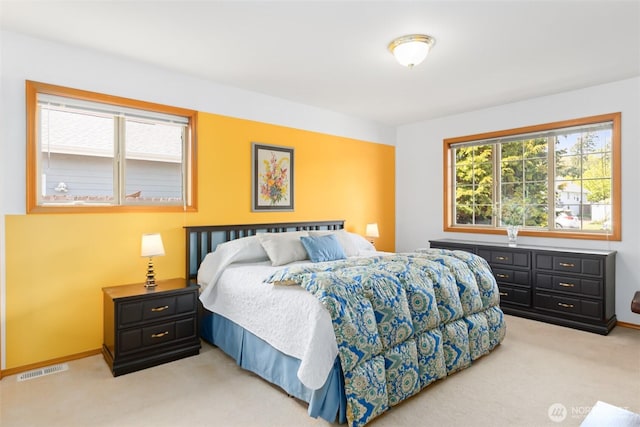 bedroom featuring light colored carpet, baseboards, and visible vents