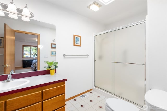 ensuite bathroom featuring visible vents, a shower with shower door, vanity, toilet, and ensuite bath