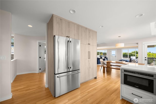 6117 92nd St SW, Mukilteo, WA 98275 - kitchen featuring high quality fridge, light brown cabinetry, light wood finished floors, oven, and recessed lighting