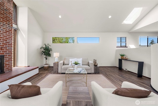 11815 77th Ave S, Seattle, WA 98178 - living room with a skylight, wood finished floors, high vaulted ceiling, and recessed lighting
