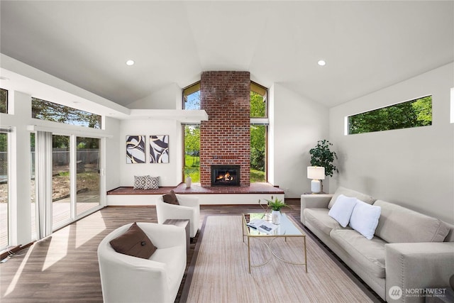 11815 77th Ave S, Seattle, WA 98178 - living area featuring vaulted ceiling, wood finished floors, and a brick fireplace