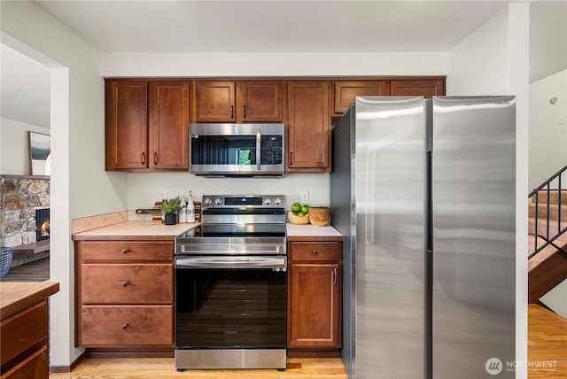 11815 77th Ave S, Seattle, WA 98178 - kitchen featuring appliances with stainless steel finishes, light countertops, and light wood-style floors