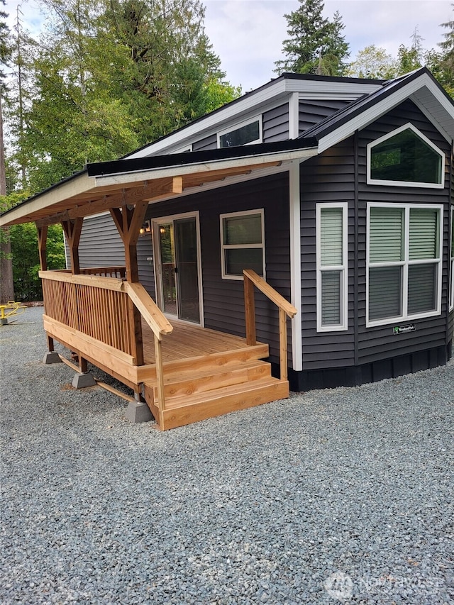rear view of house featuring covered porch
