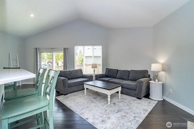 living room featuring vaulted ceiling, dark wood finished floors, and baseboards