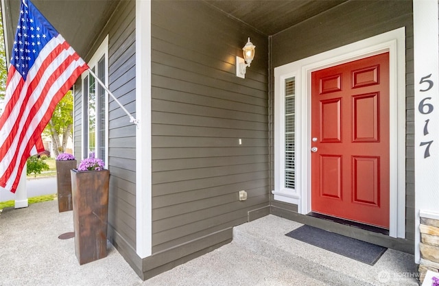 view of exterior entry featuring covered porch