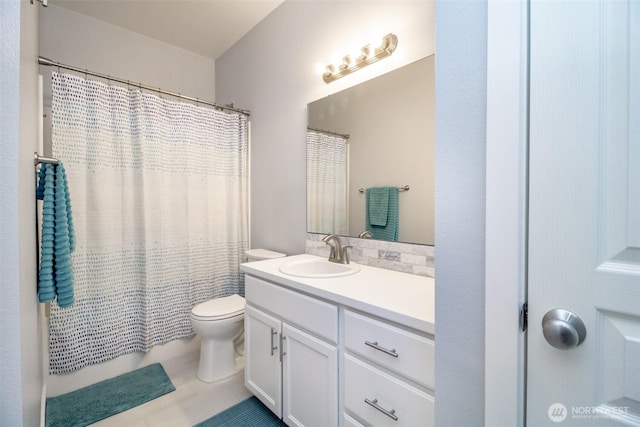 bathroom featuring toilet, vanity, and shower / tub combo