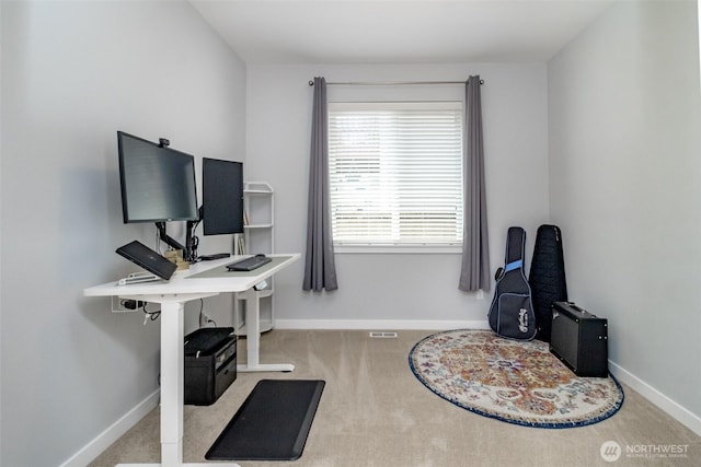 carpeted home office featuring baseboards