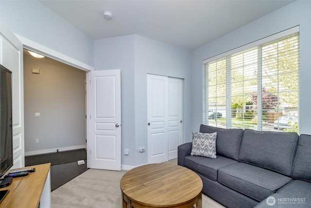 living area featuring light colored carpet