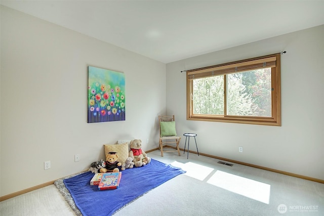 carpeted bedroom featuring baseboards and visible vents