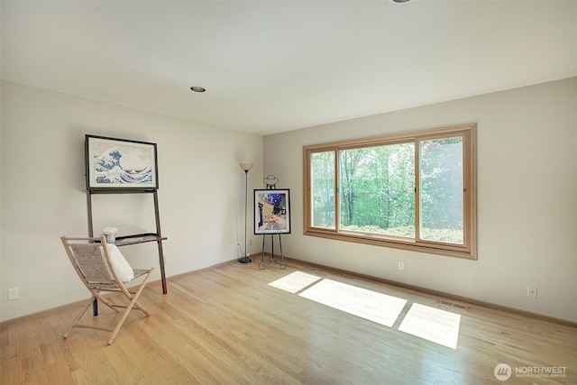 unfurnished room featuring light wood-type flooring and baseboards