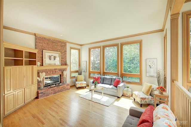 living area featuring a healthy amount of sunlight, crown molding, a brick fireplace, and light wood finished floors