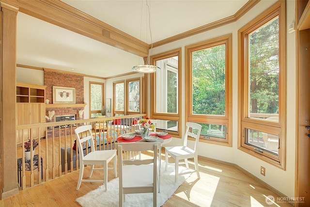 sunroom featuring crown molding and wood finished floors