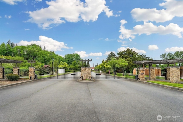 825 Harrington Pl SE Unit 2145, Renton, WA 98058 - view of asphalt street with a gate, a gated entry, and curbs