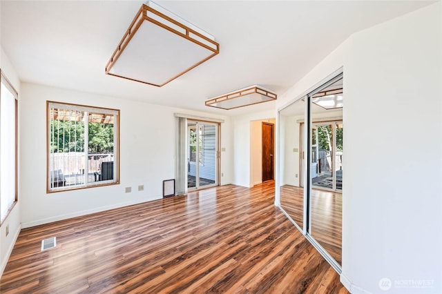 1332 Orchard Ave, Wenatchee, WA 98801 - empty room featuring wood finished floors, plenty of natural light, and baseboards
