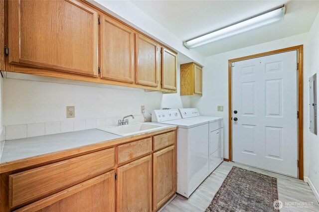 1332 Orchard Ave, Wenatchee, WA 98801 - laundry area featuring cabinet space, separate washer and dryer, light wood-style flooring, and electric panel
