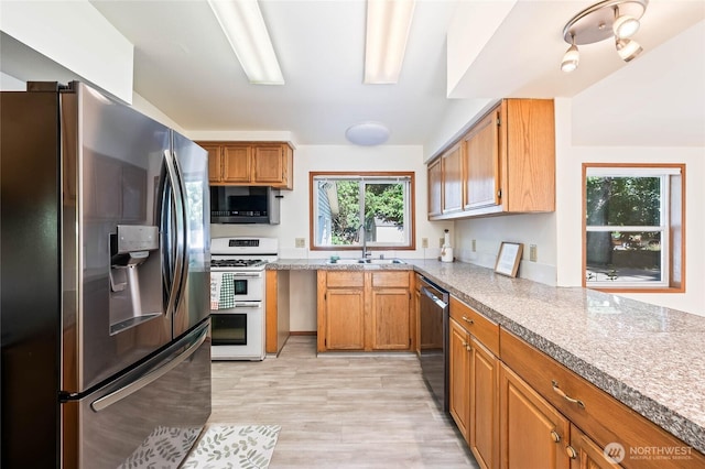 1332 Orchard Ave, Wenatchee, WA 98801 - kitchen with stainless steel fridge, range with two ovens, black microwave, dishwashing machine, and a sink