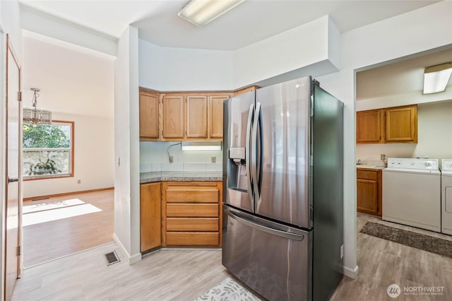 1332 Orchard Ave, Wenatchee, WA 98801 - kitchen featuring stainless steel fridge, washing machine and dryer, light wood finished floors, and baseboards