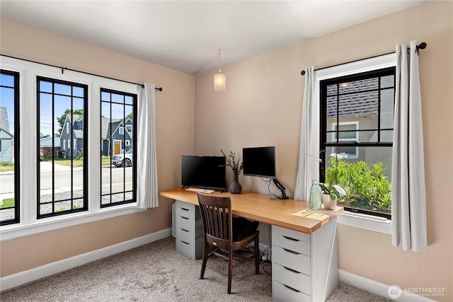 office space featuring baseboards and light colored carpet
