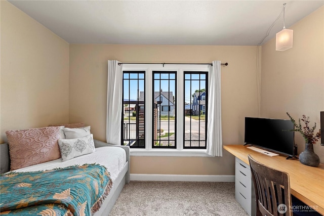 bedroom featuring baseboards and light colored carpet