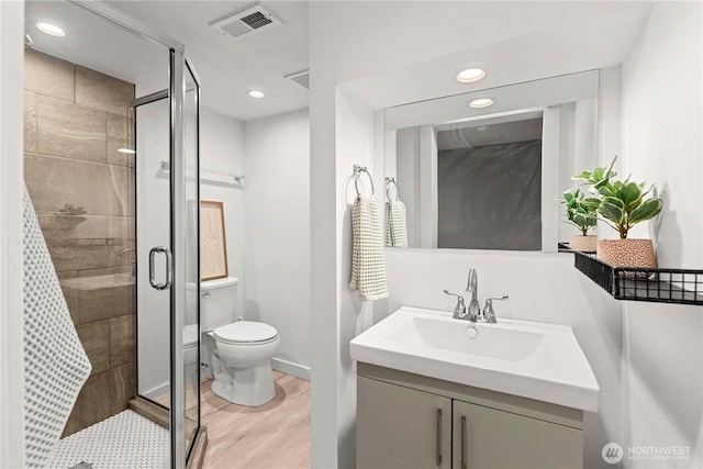 bathroom featuring a shower stall, recessed lighting, wood finished floors, and visible vents