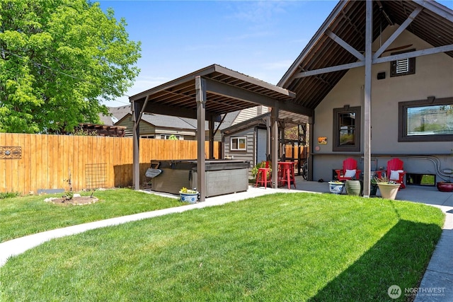 view of yard with a patio area, a hot tub, and fence