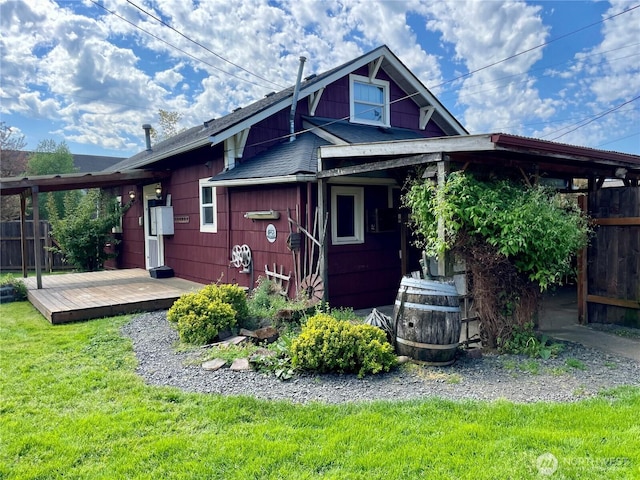 back of house featuring a yard, fence, and a wooden deck