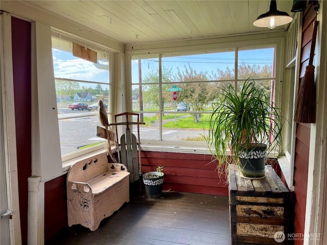 sunroom with a wealth of natural light and hardwood / wood-style flooring