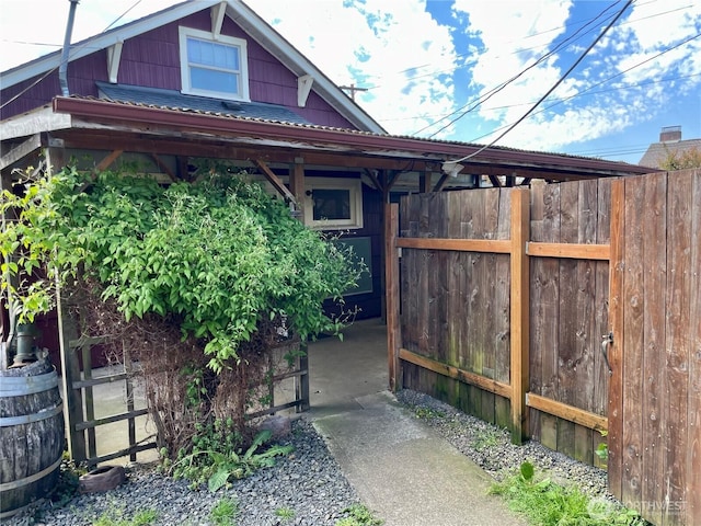 view of home's exterior with fence and metal roof